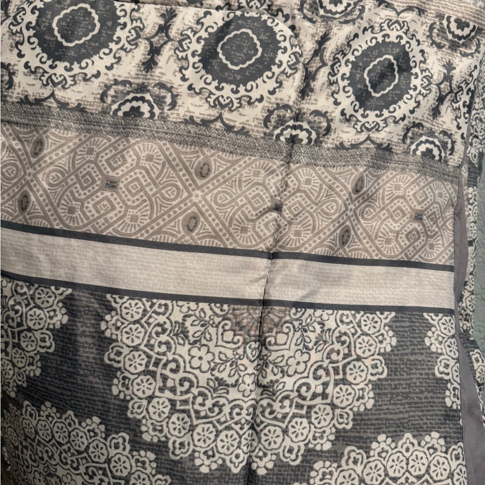Gray and Cream Patterned Quilt